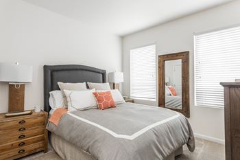 a bedroom with a large bed and a mirror at 310 at Nulu Apartments-Student, Louisville